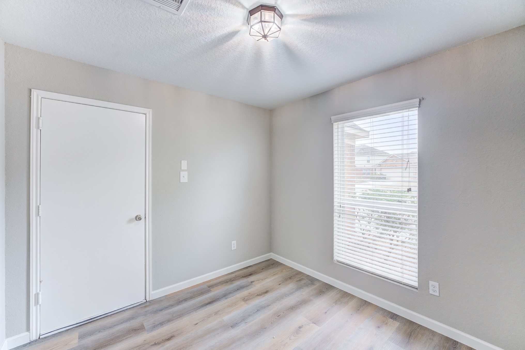 8038 Narrow Brook Way Houston, TX 77016 - Photo 17 of 50 an empty room with a window and wooden floor