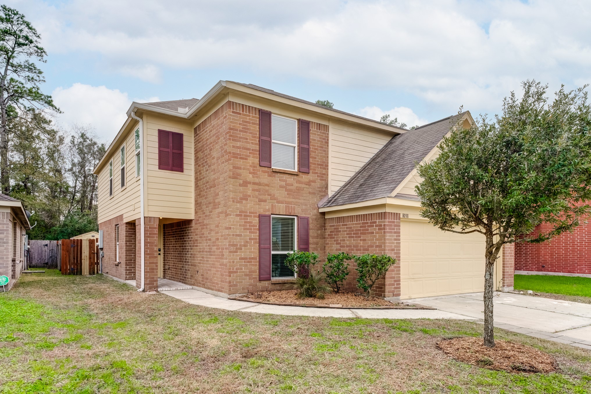 8038 Narrow Brook Way Houston, TX 77016 - Photo 2 of 50 a front view of a house with a yard and garage
