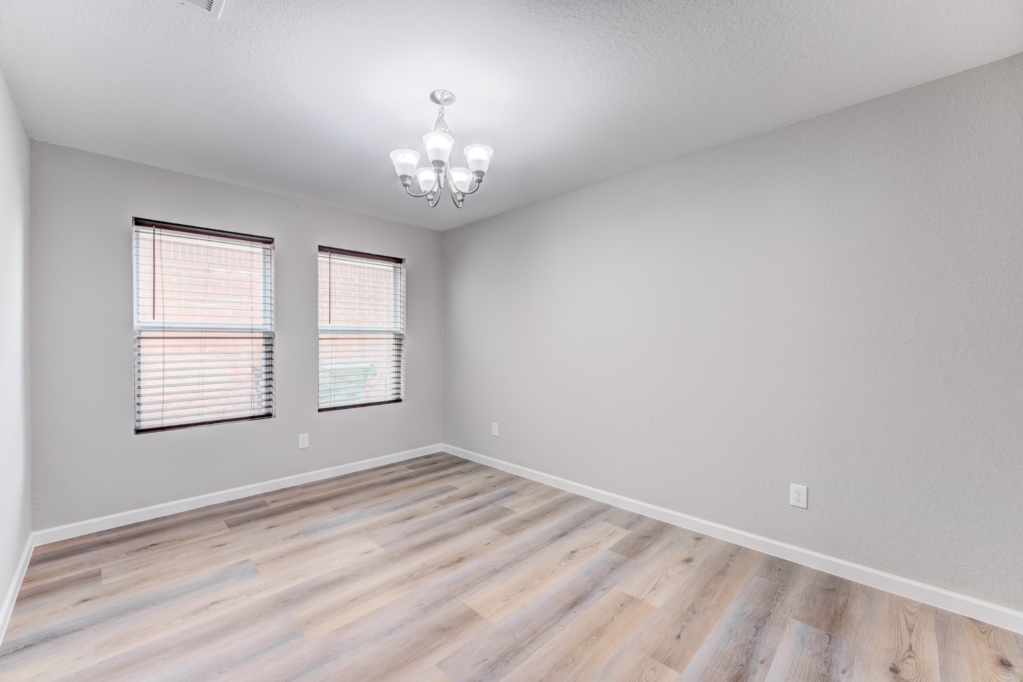 8038 Narrow Brook Way Houston, TX 77016 - Photo 21 of 50 an empty room with a chandelier