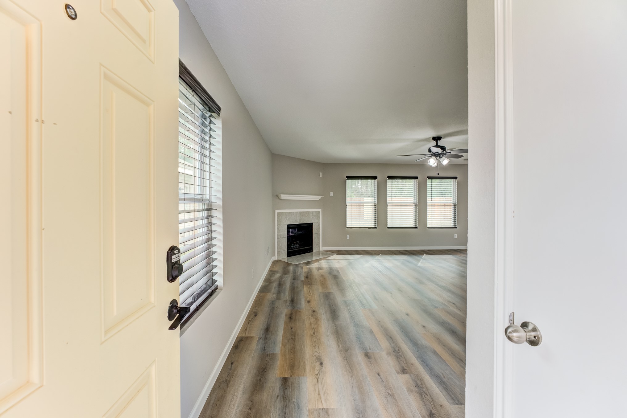 8038 Narrow Brook Way Houston, TX 77016 - Photo 5 of 50 a view of an empty room with wooden floor and a window