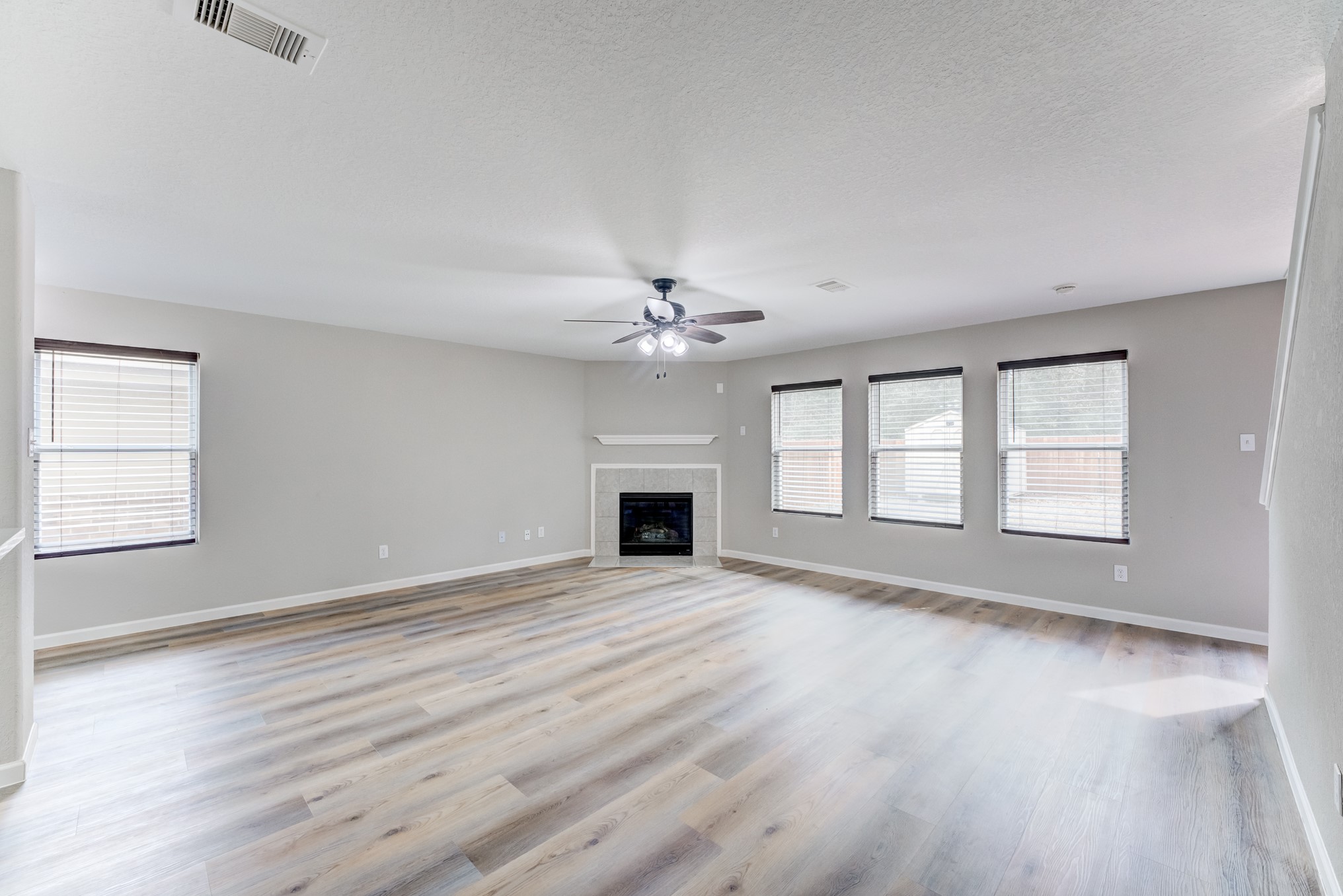 8038 Narrow Brook Way Houston, TX 77016 - Photo 7 of 50 an empty room with windows and fireplace