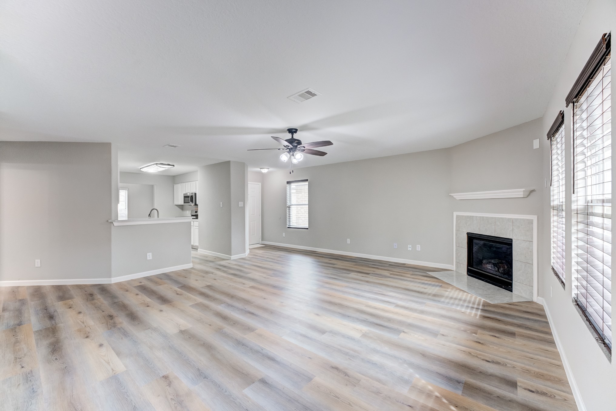 8038 Narrow Brook Way Houston, TX 77016 - Photo 9 of 50 wooden floor in an empty room with a fireplace