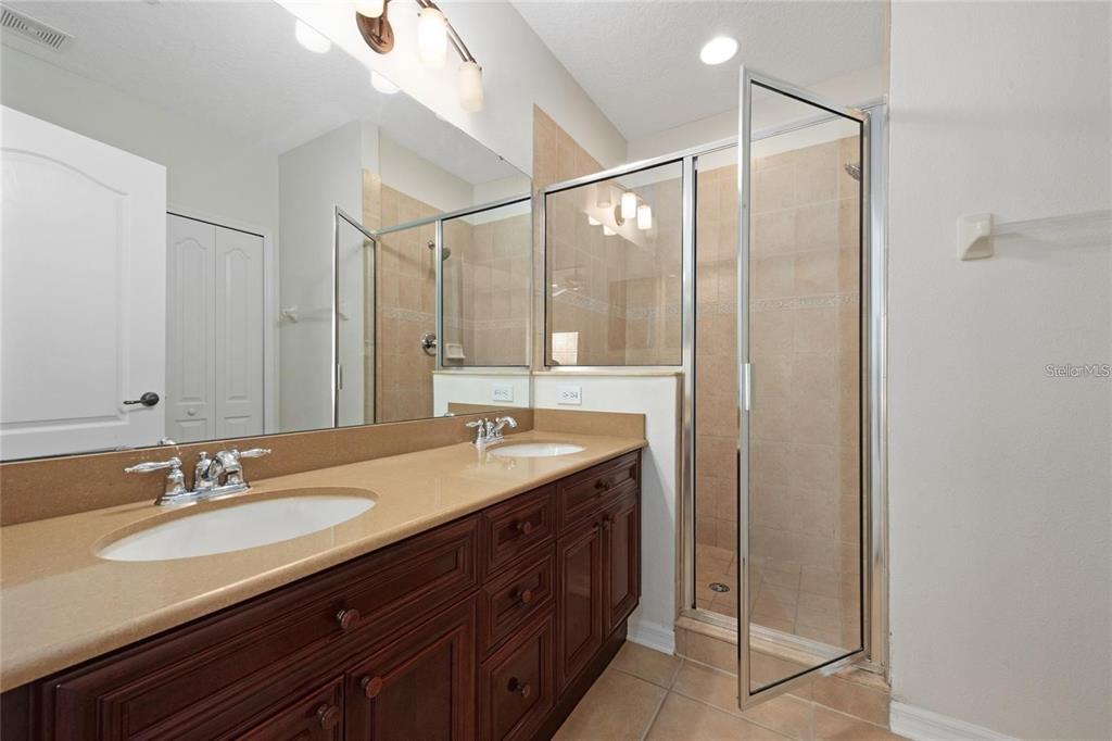 5957 Strada Capri Way Orlando, FL 32835 - Photo 12 of 20 a bathroom with a double vanity sink and mirror