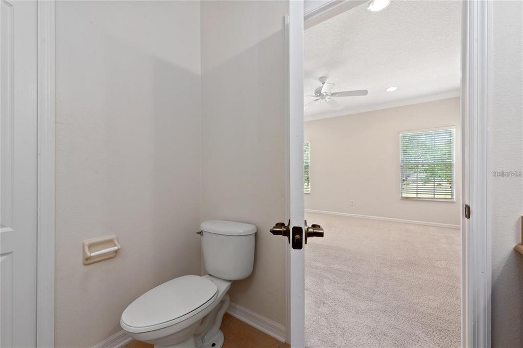 5957 Strada Capri Way Orlando, FL 32835 - Photo 13 of 20 a white toilet sitting next to a bathroom sink