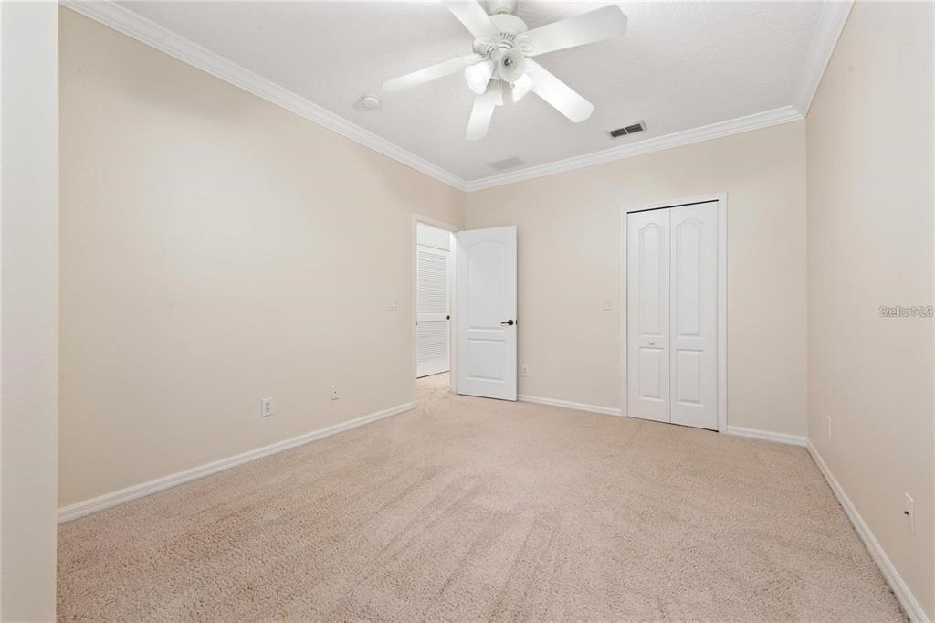 5957 Strada Capri Way Orlando, FL 32835 - Photo 16 of 20 an empty room with a ceiling fan and a window