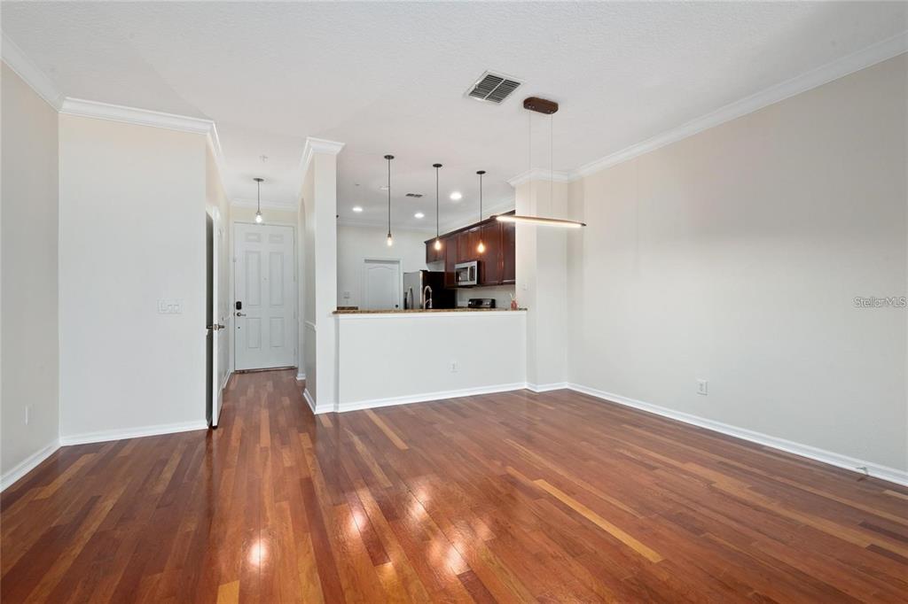 5957 Strada Capri Way Orlando, FL 32835 - Photo 6 of 20 a view of a room with wooden floor and white walls
