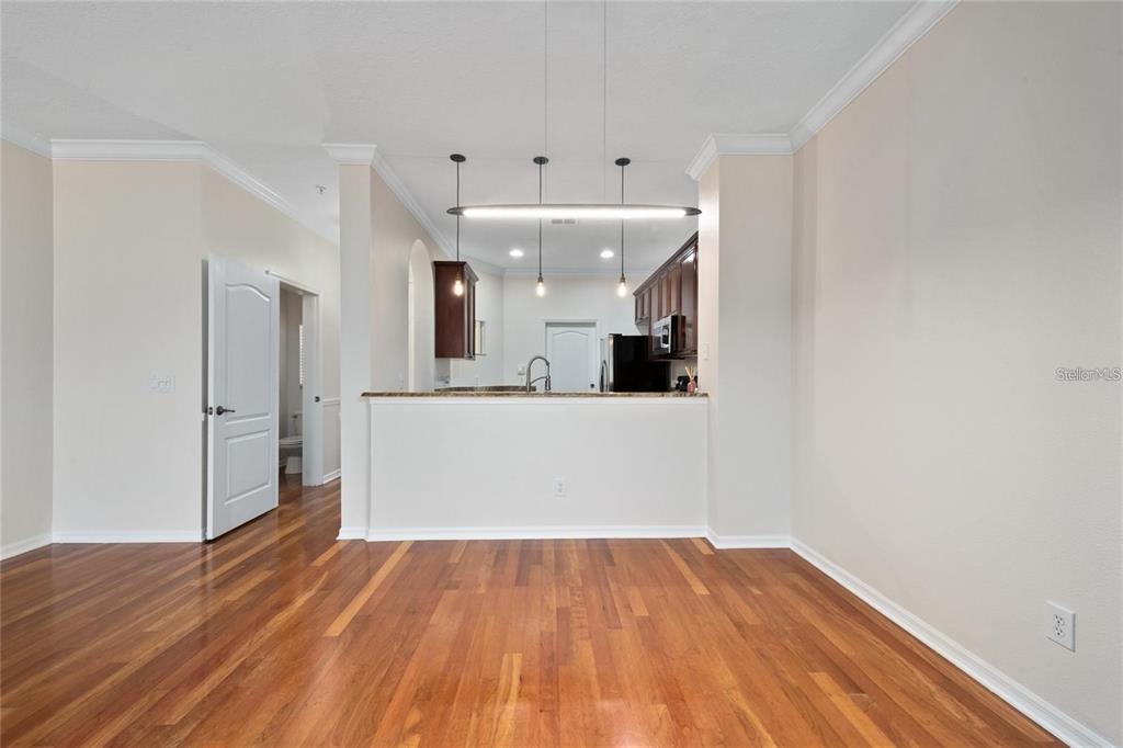 5957 Strada Capri Way Orlando, FL 32835 - Photo 7 of 20 a view of a hallway with wooden floor and staircase