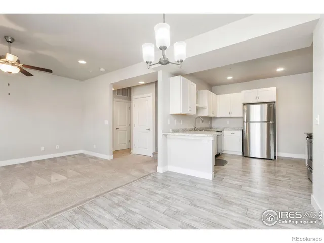 a view of a kitchen with a sink and a refrigerator