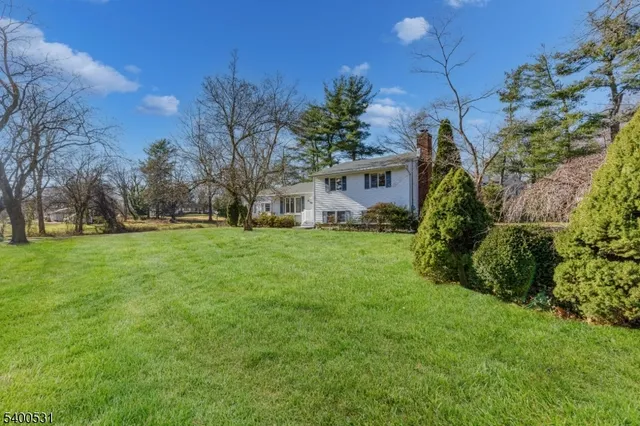 a view of house with backyard