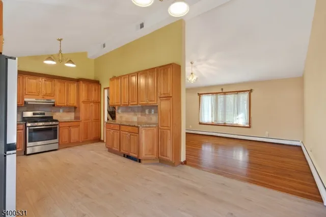 a kitchen with a refrigerator and a stove top oven