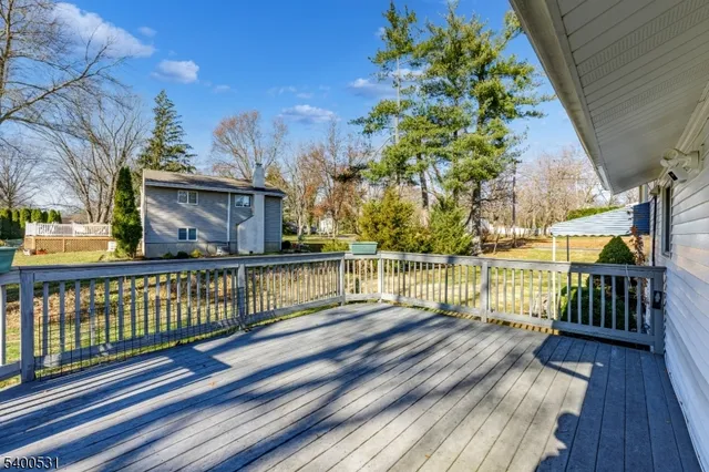 a view of balcony with wooden floor and fence