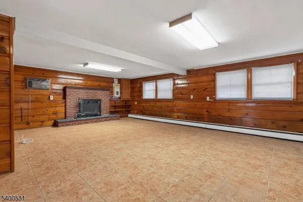an empty room with fireplace and window