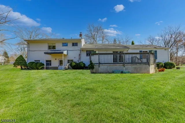 a view of a house with a big yard and potted plants