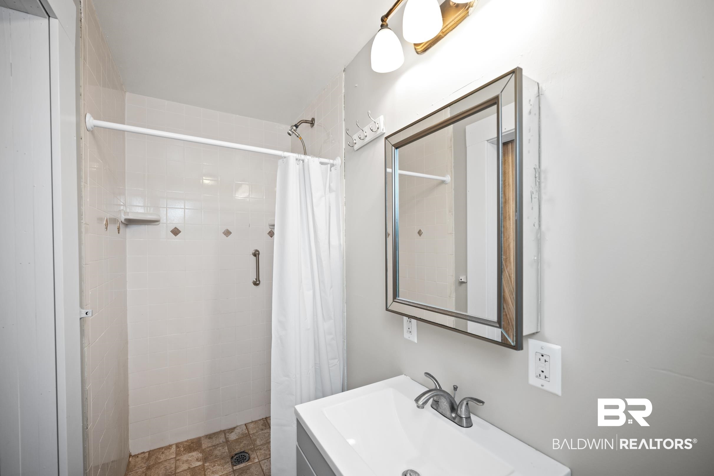 496 Elberta Loop Lillian, AL 36549 - Photo 10 of 29 Full bathroom with a tile shower and vanity