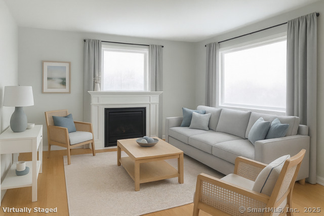 23 Meadow Brook Road West Haven, CT 06516 - Photo 13 of 39 a living room with furniture a large window and a fireplace