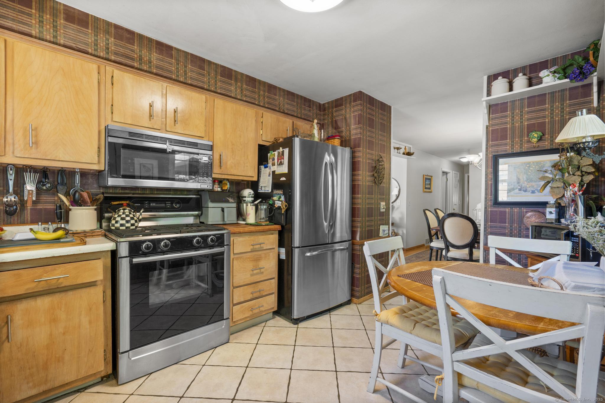 23 Meadow Brook Road West Haven, CT 06516 - Photo 17 of 39 a kitchen with stainless steel appliances granite countertop a stove a refrigerator and a microwave