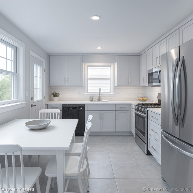 23 Meadow Brook Road West Haven, CT 06516 - Photo 21 of 39 a kitchen with a refrigerator a stove a sink dishwasher with a dining table and chairs