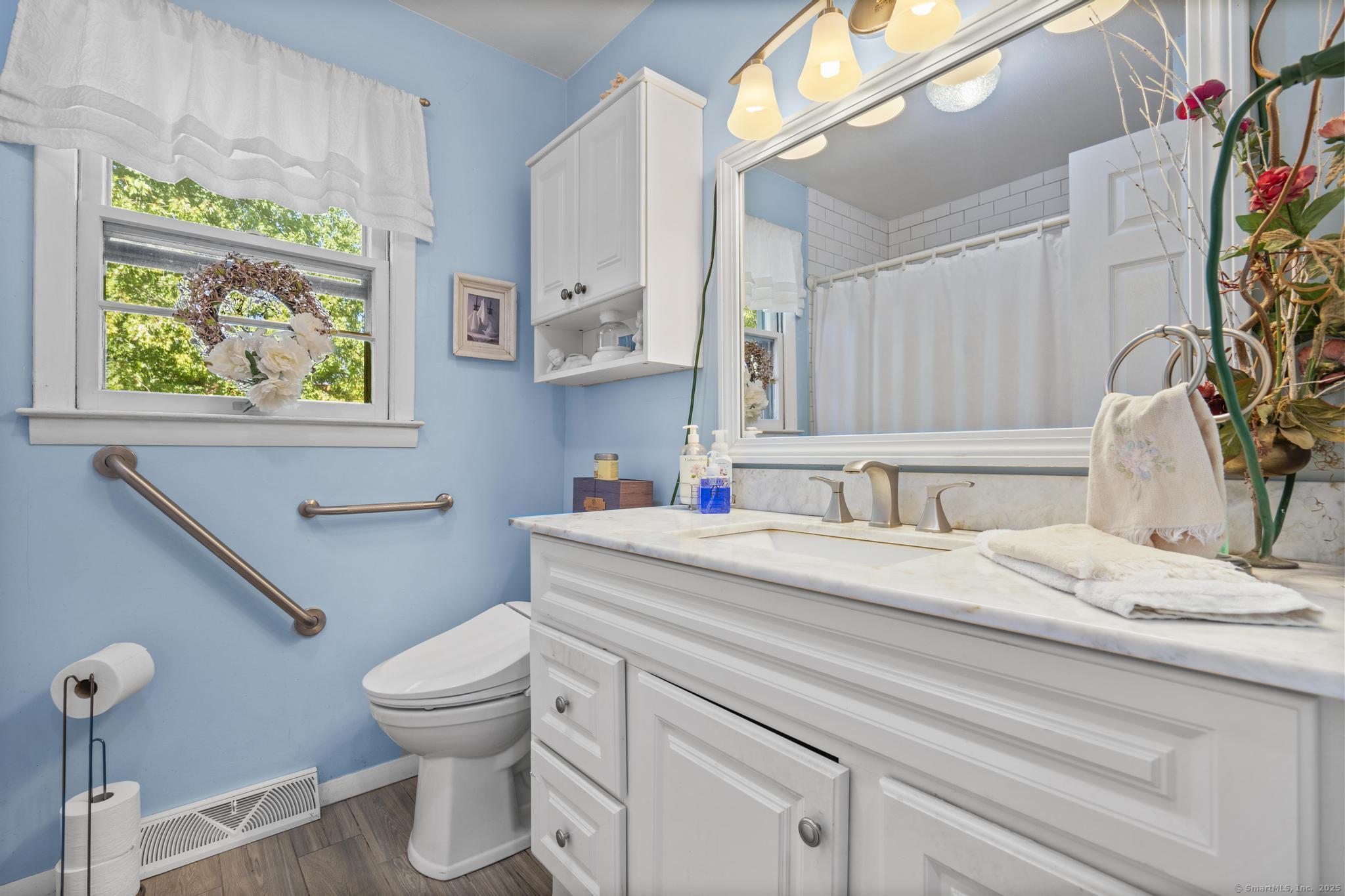 23 Meadow Brook Road West Haven, CT 06516 - Photo 22 of 39 a bathroom with a sink a toilet and a window