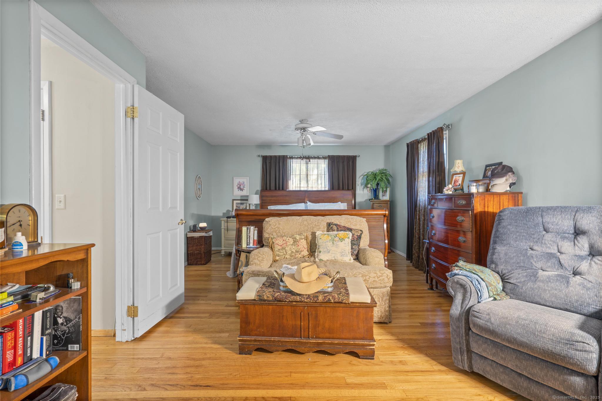 23 Meadow Brook Road West Haven, CT 06516 - Photo 24 of 39 a living room with furniture and a wooden floor