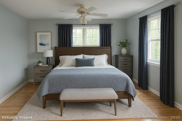 23 Meadow Brook Road West Haven, CT 06516 - Photo 25 of 39 a bedroom with a bed table closet and two windows