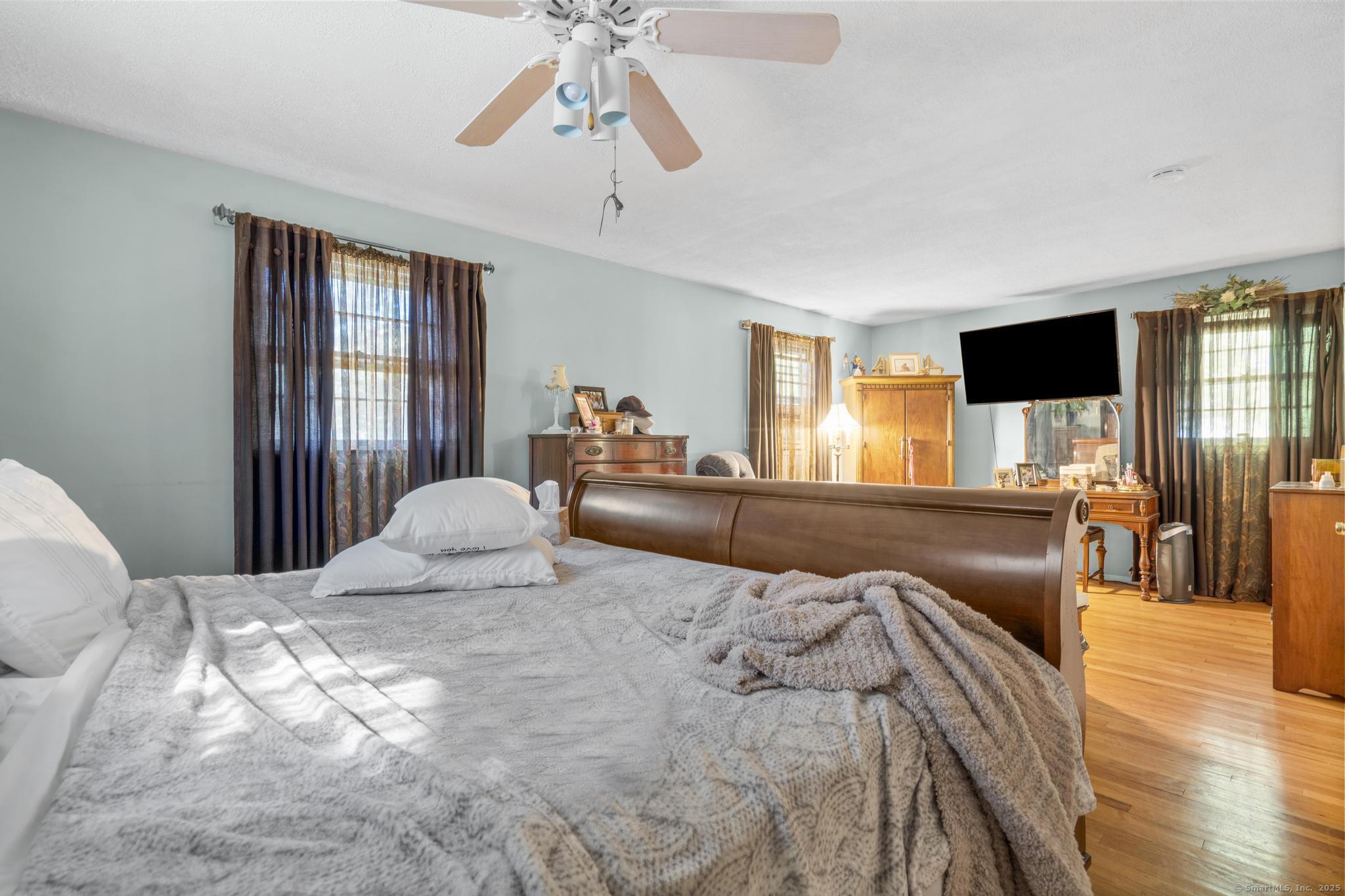 23 Meadow Brook Road West Haven, CT 06516 - Photo 27 of 39 a bedroom with a large bed and a chandelier