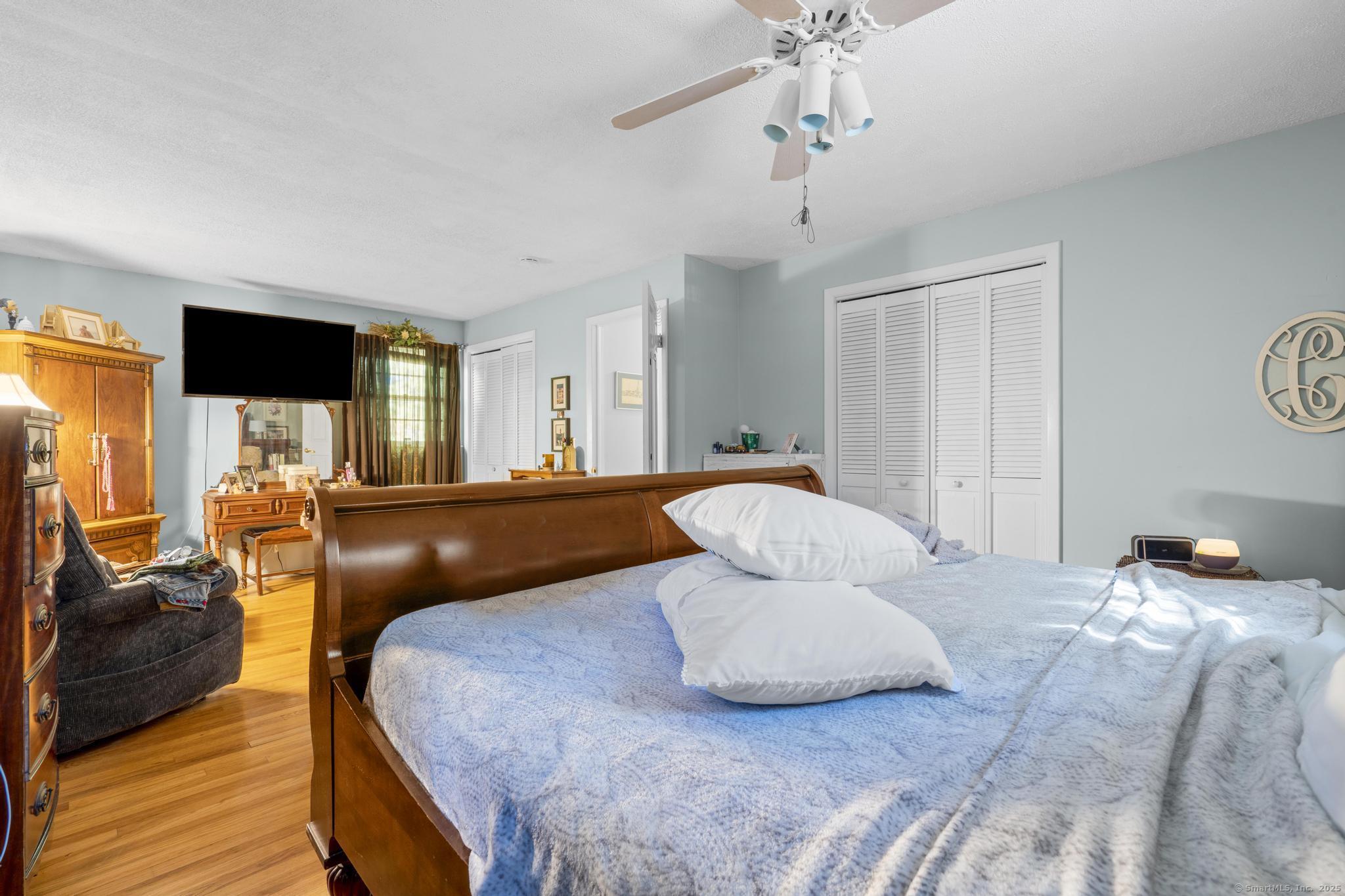 23 Meadow Brook Road West Haven, CT 06516 - Photo 28 of 39 a bedroom with a bed and wooden floor