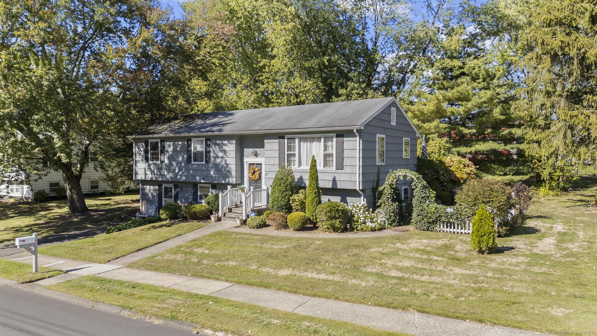 23 Meadow Brook Road West Haven, CT 06516 - Photo 3 of 39 a view of a house with potted plants and large trees
