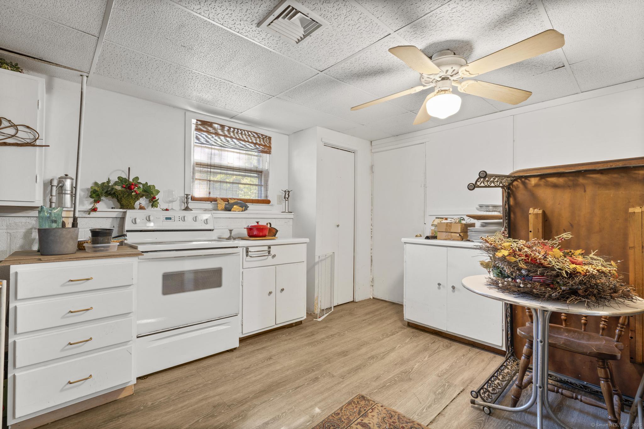 23 Meadow Brook Road West Haven, CT 06516 - Photo 34 of 39 a kitchen with a white cabinets and stove