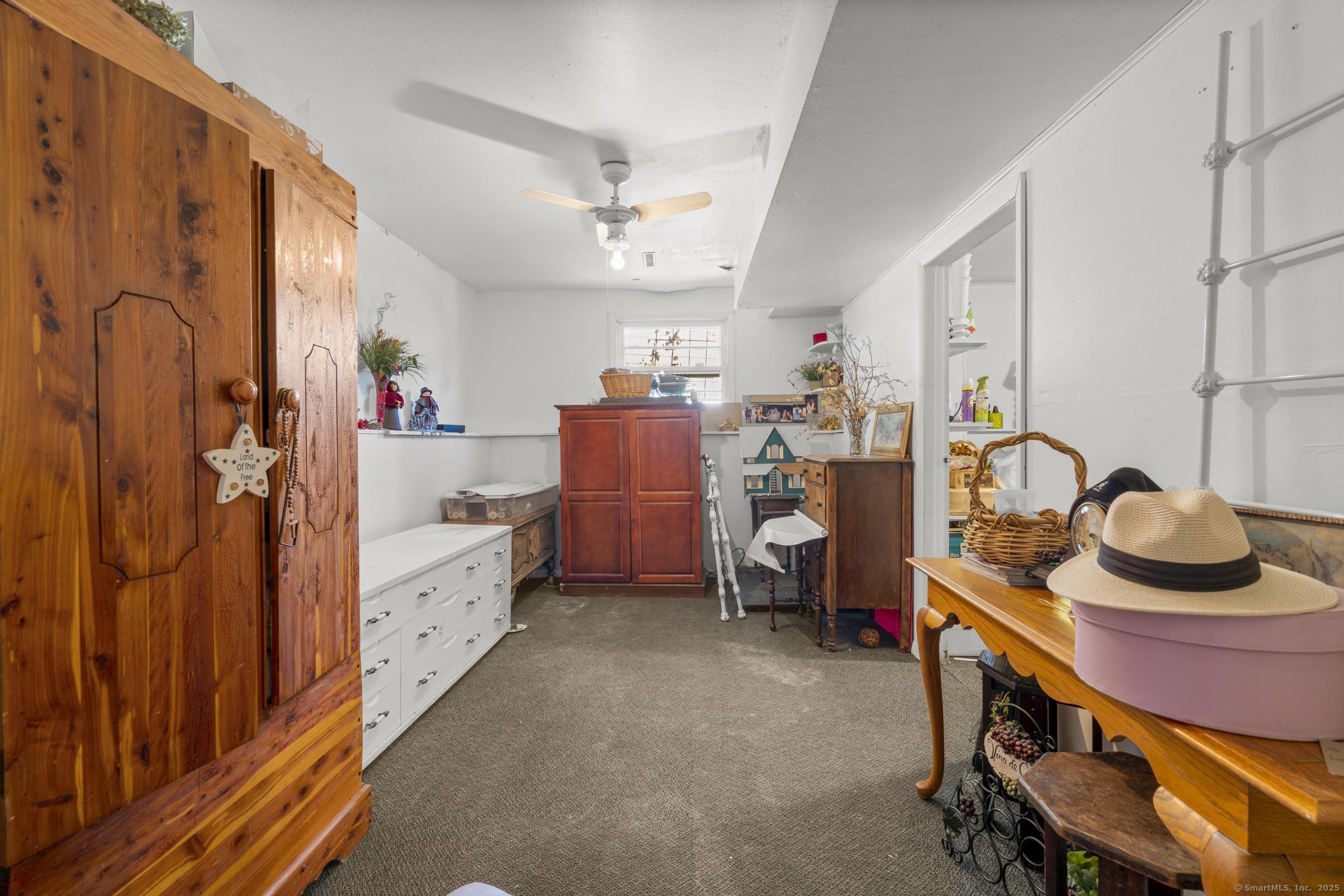 23 Meadow Brook Road West Haven, CT 06516 - Photo 38 of 39 a room with furniture a chandelier couch a rug and a window