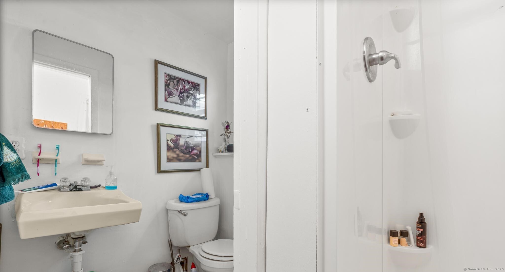 23 Meadow Brook Road West Haven, CT 06516 - Photo 39 of 39 a bathroom with a toilet sink and mirror