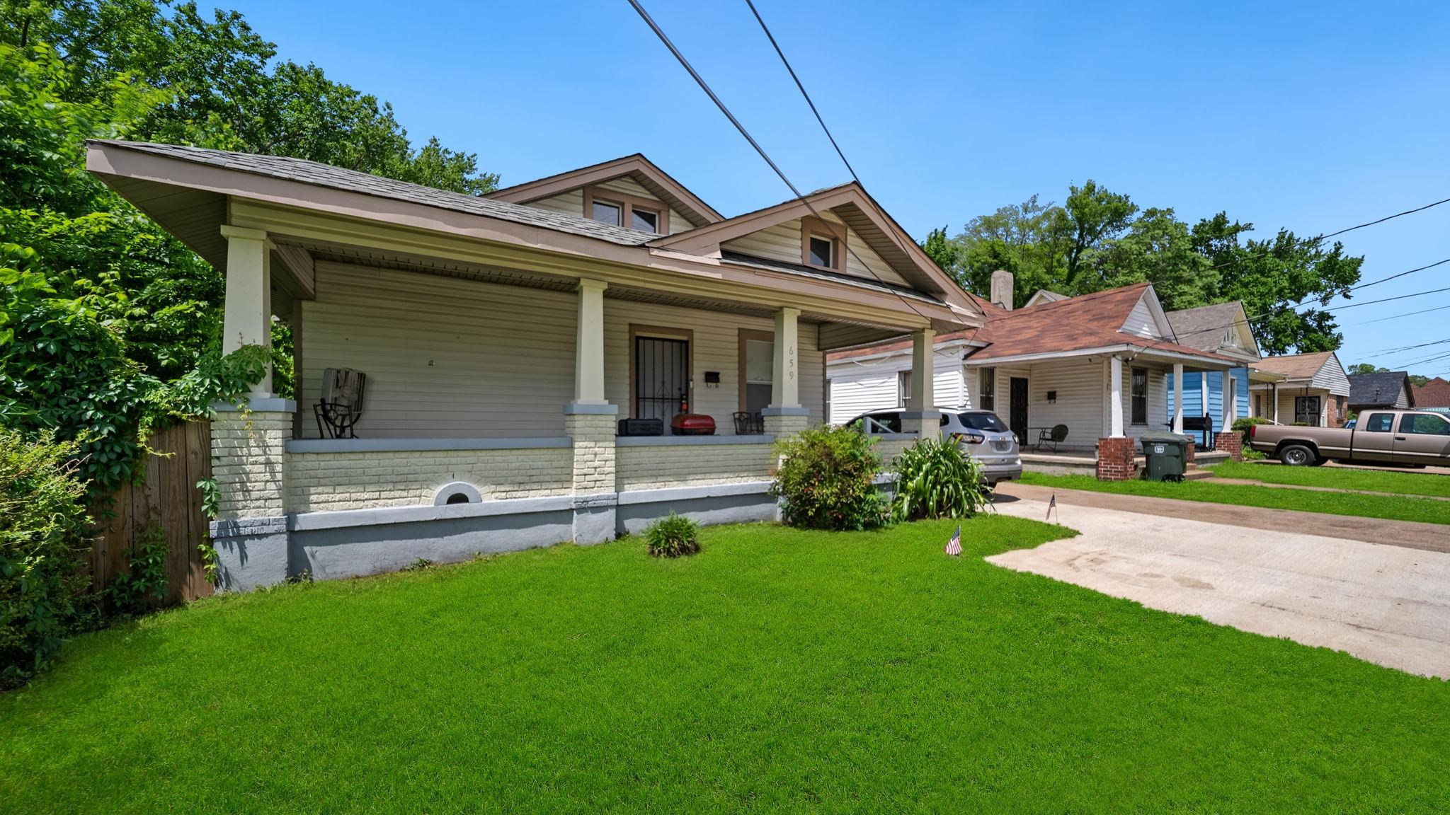 659 Decatur Street Memphis, TN 38107 - Photo 3 of 24 Traditional-style residence featuring a prominent covered front porch with substantial columns, a light-colored brick foundation, and a pitched roofline