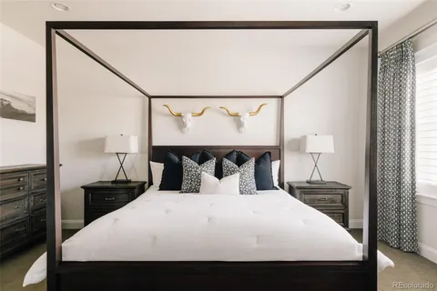 a bedroom with a bed and a night stand