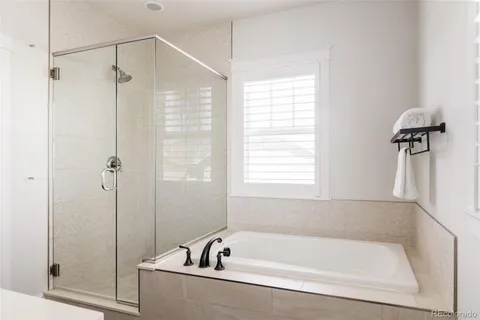 a white bath tub sitting next to a shower