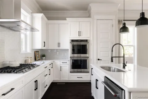 a kitchen with a stove a sink and a refrigerator