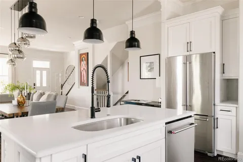a kitchen with stainless steel appliances granite countertop a refrigerator and a sink