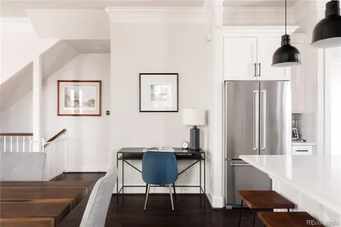 a view of a workspace with furniture and wooden floor