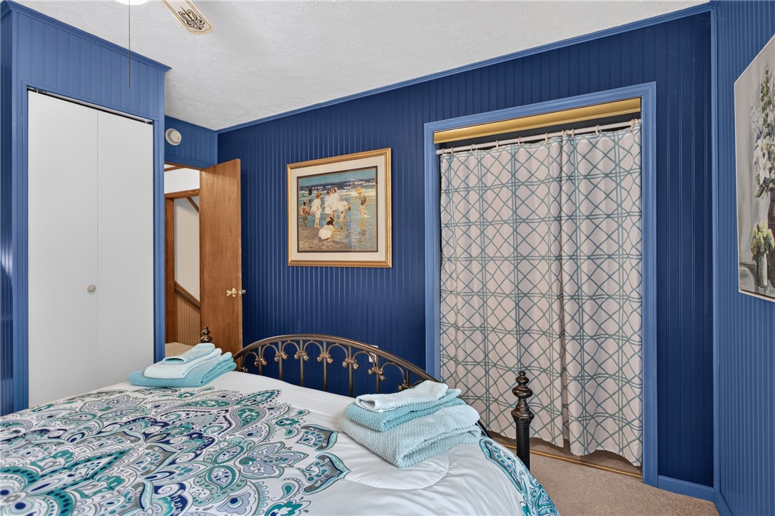 351 River Road Westminster, SC 29693 - Photo 30 of 50 Bold blue beadboard walls and soft carpeting define this inviting and comfortable bedroom.