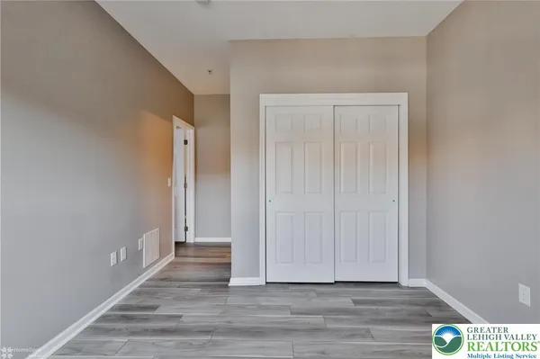 a view of a room with wooden floor and cabinet