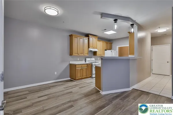 a view of kitchen with granite countertop cabinets and wooden floor