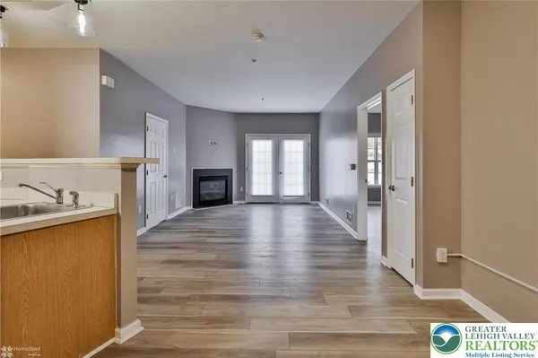 a view of a room with wooden floor and white walls