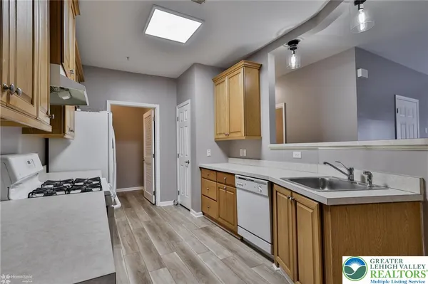 a kitchen with a sink stove and cabinets