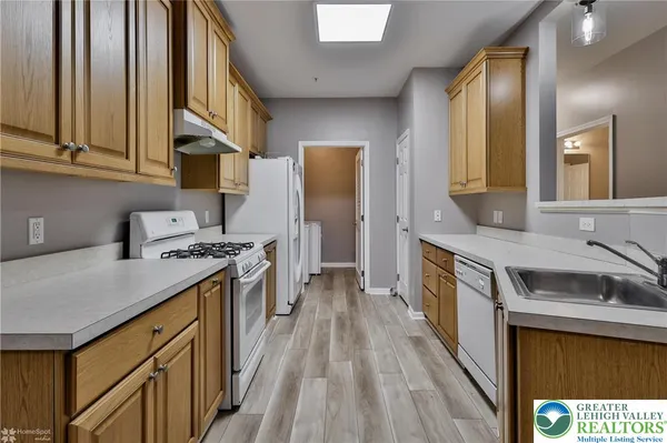 a kitchen with stainless steel appliances granite countertop a stove and a refrigerator