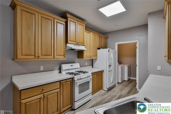 a kitchen with stainless steel appliances granite countertop a sink stove and cabinets