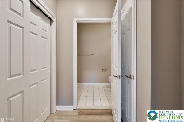 a white toilet sitting next to a bath tub