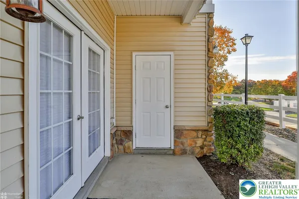 a view of a patio with table and chairs next to a yard
