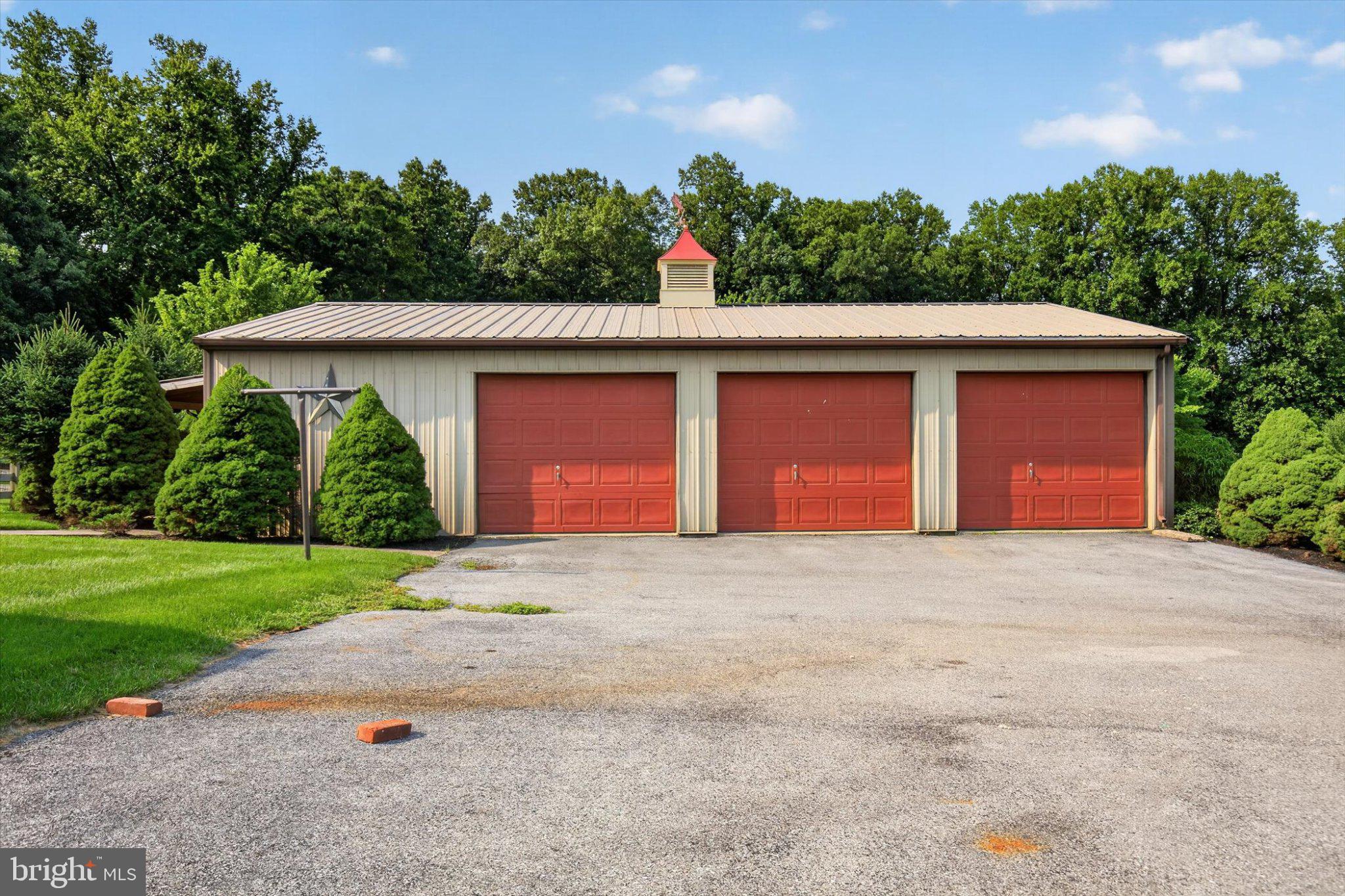 239 Lawn Road Palmyra, PA 17078 - Photo 34 of 64 Charming garage with lush greenery.