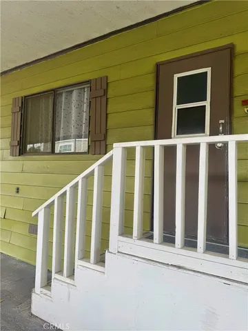 a view of a chairs and bench in the roof deck