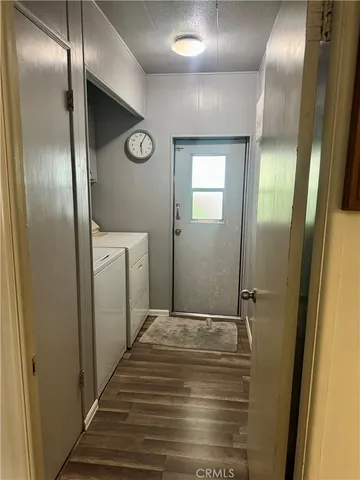 a view of a living room with furniture and wooden floor