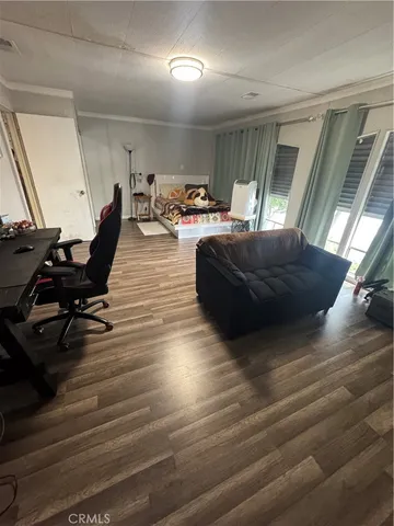 a room with a table chairs and wooden floor