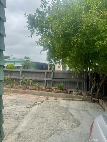 a backyard of a house with wooden fence